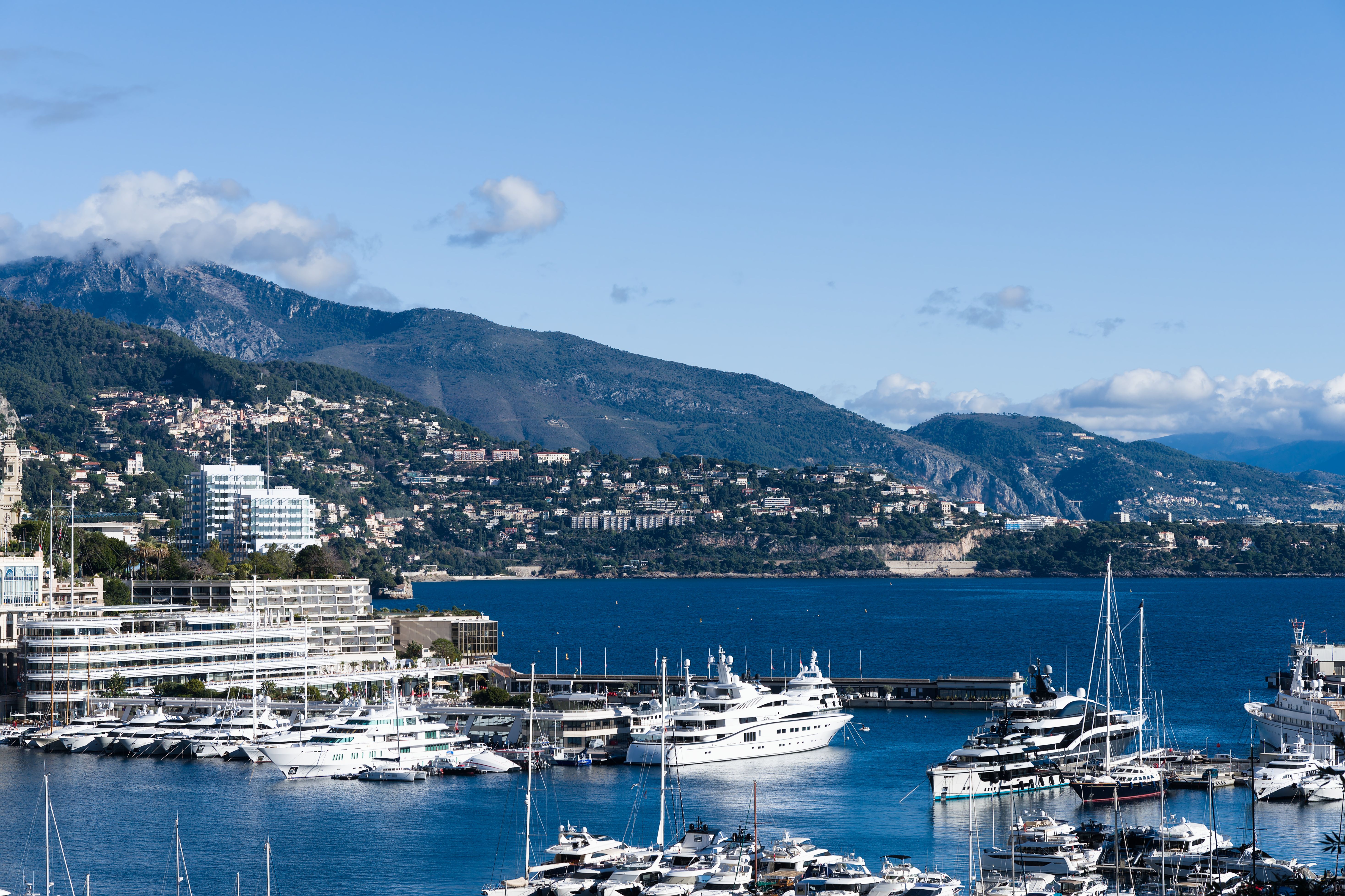 Spectacular Private Full-Day Tour on the French Riviera from Monaco Review 2026 - A breathtaking scene of Monaco's marina with luxury yachts and mountains in the backdrop.
