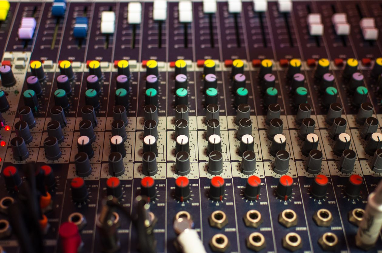 Close view of a mixing console with colorful knobs