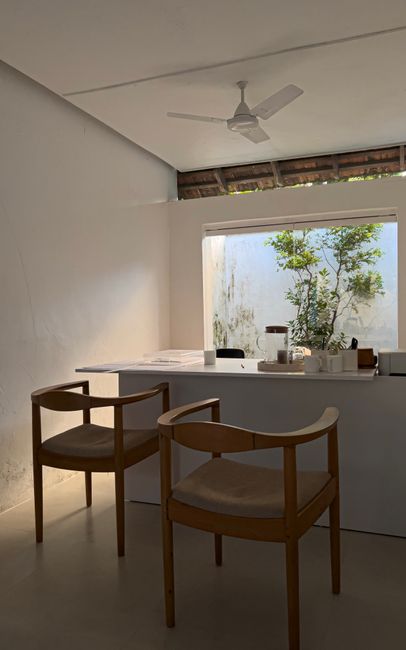 Photo by Jomin Thach A modern, minimalist office featuring sleek furniture and natural lighting.