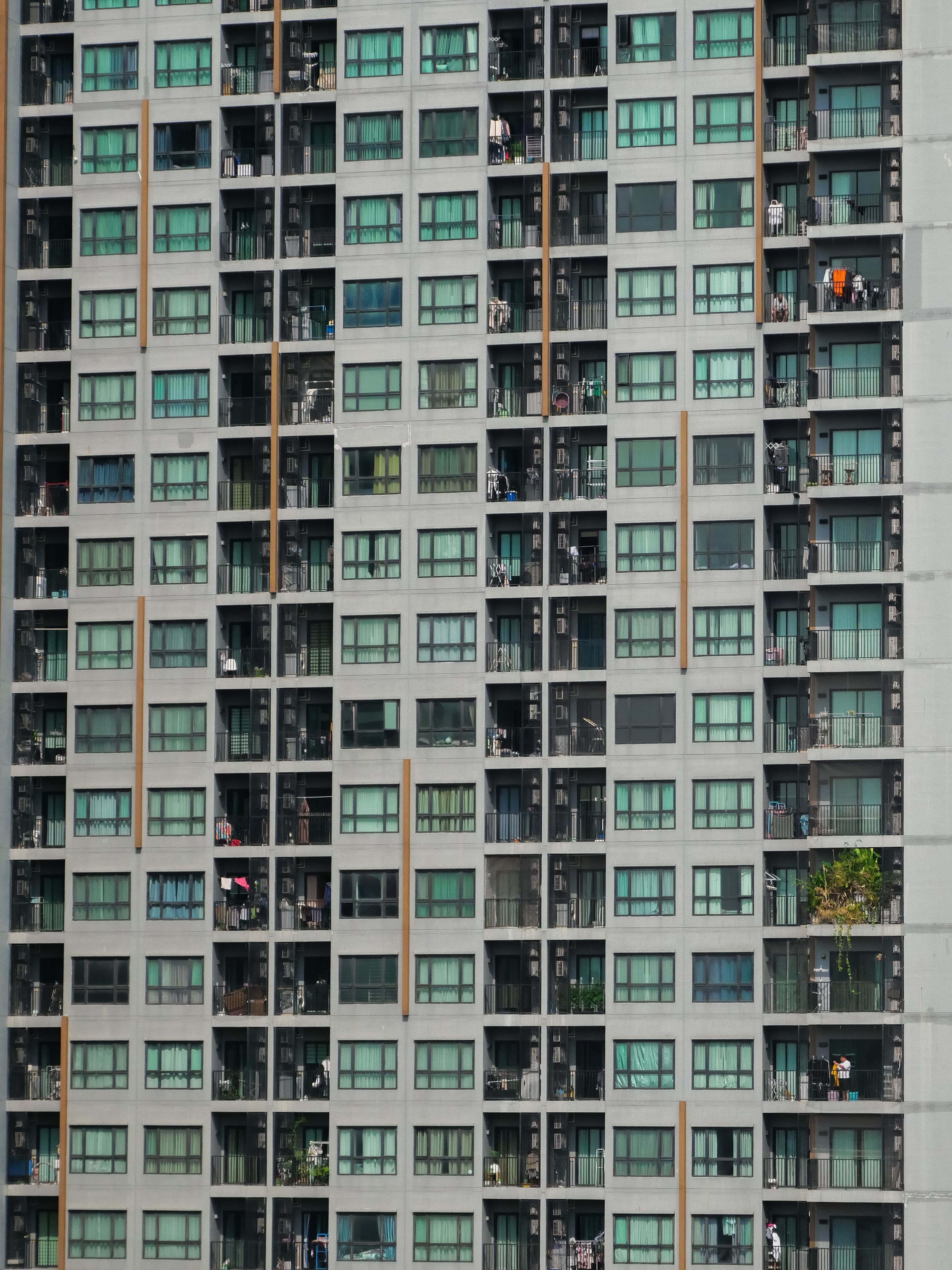 Aerial view of high-rise apartment building facade in Khon Kaen, Thailand.
