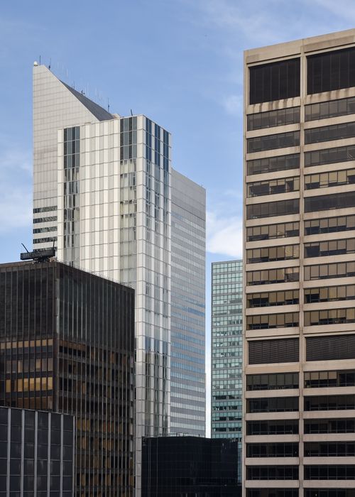 Free A collection of modern skyscrapers reflecting sunlight against a clear blue sky. Stock Photo