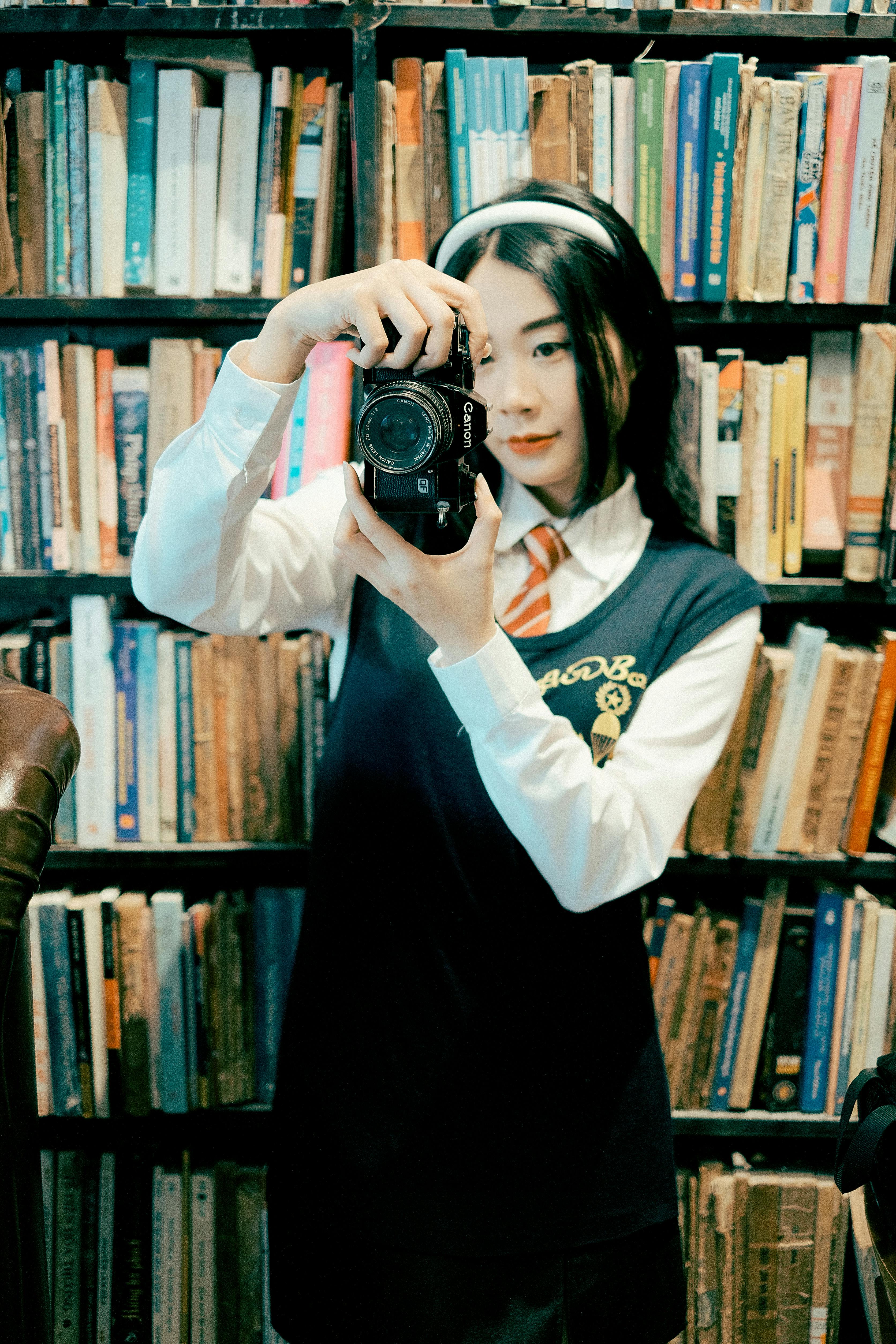 young woman taking selfie in a vintage library