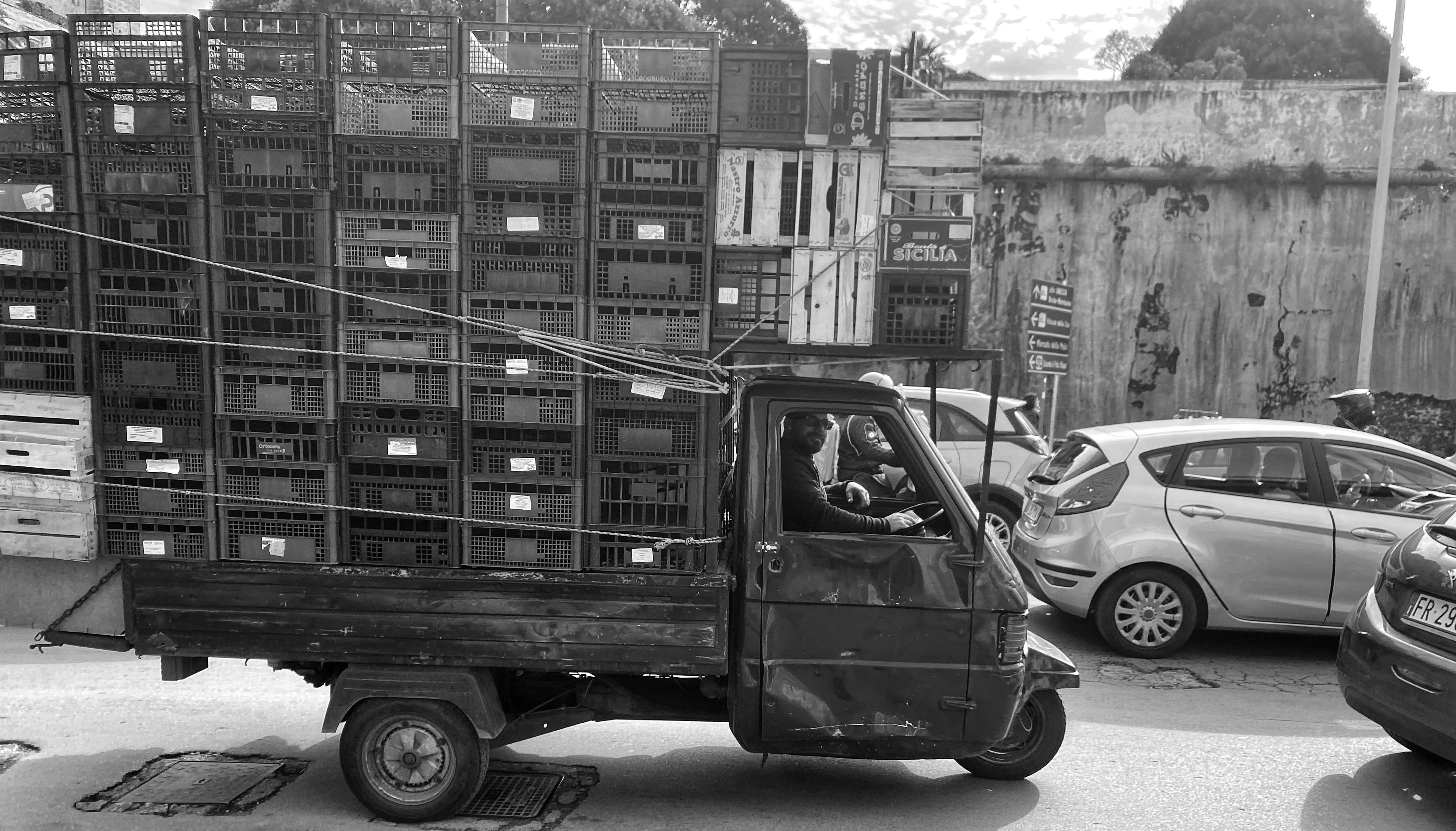 Black and white photo of a rustic truck in Palermo, Sicily, conveying local charm and everyday life.