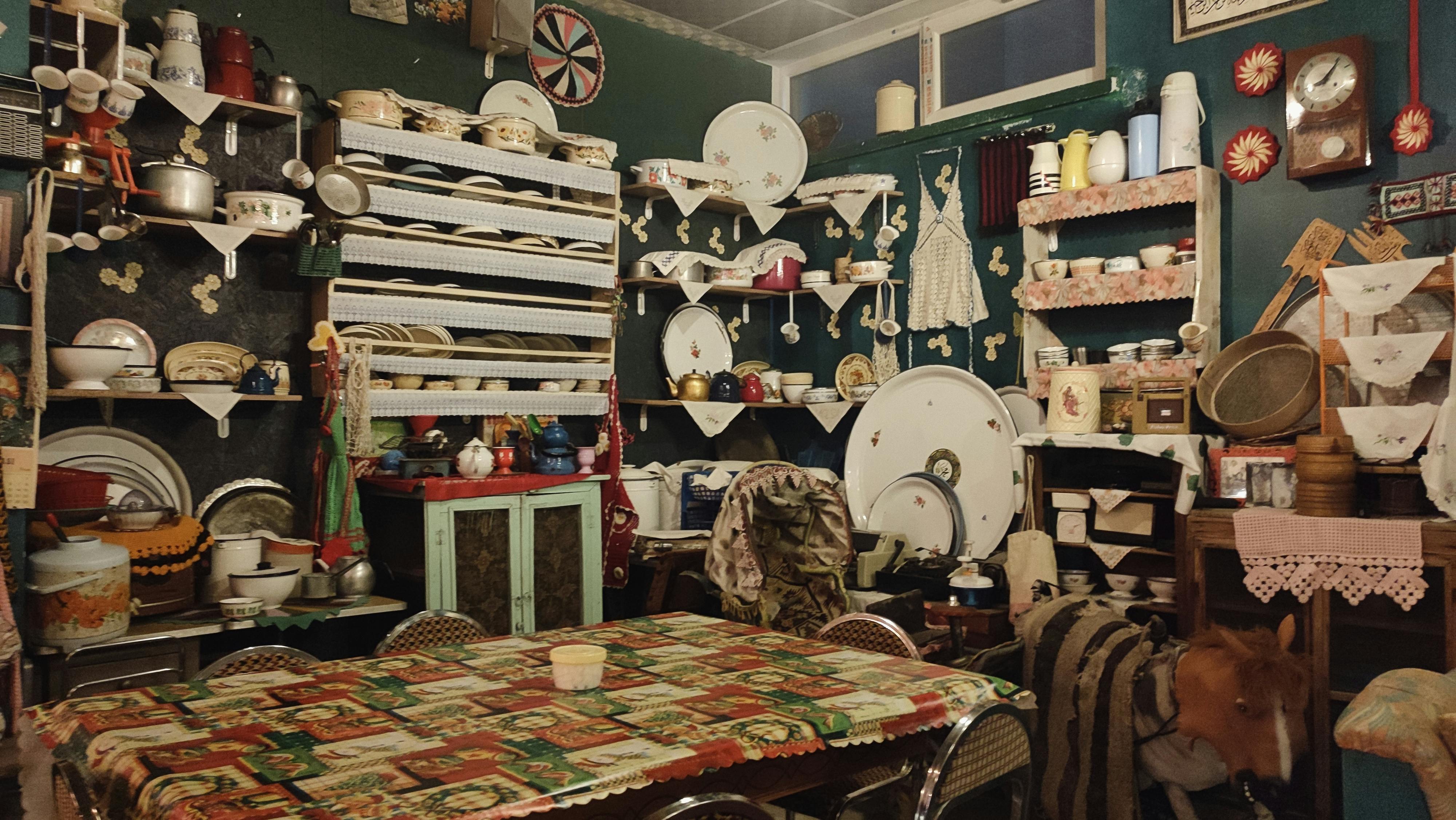 Charming vintage kitchen filled with retro decor and antique dishware, radiating a warm, nostalgic atmosphere.