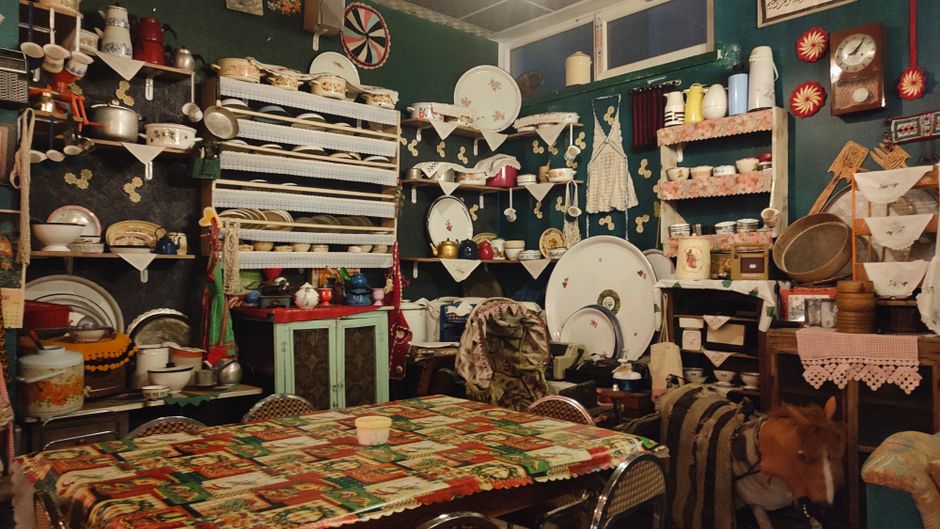 Cozy interior of a traditional Bulgarian mehana with wooden decor and folk elements.