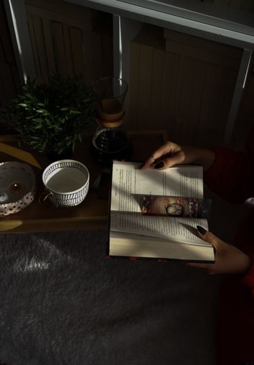 A cozy reading nook with a book and a cup of tea in soft light