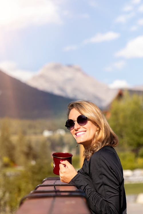 Woman Wearing Sunglasses Holding Red Cup