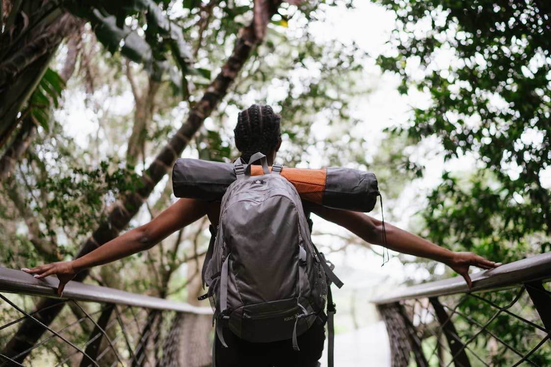 Photo Of Woman Standing On Foot Bridge 