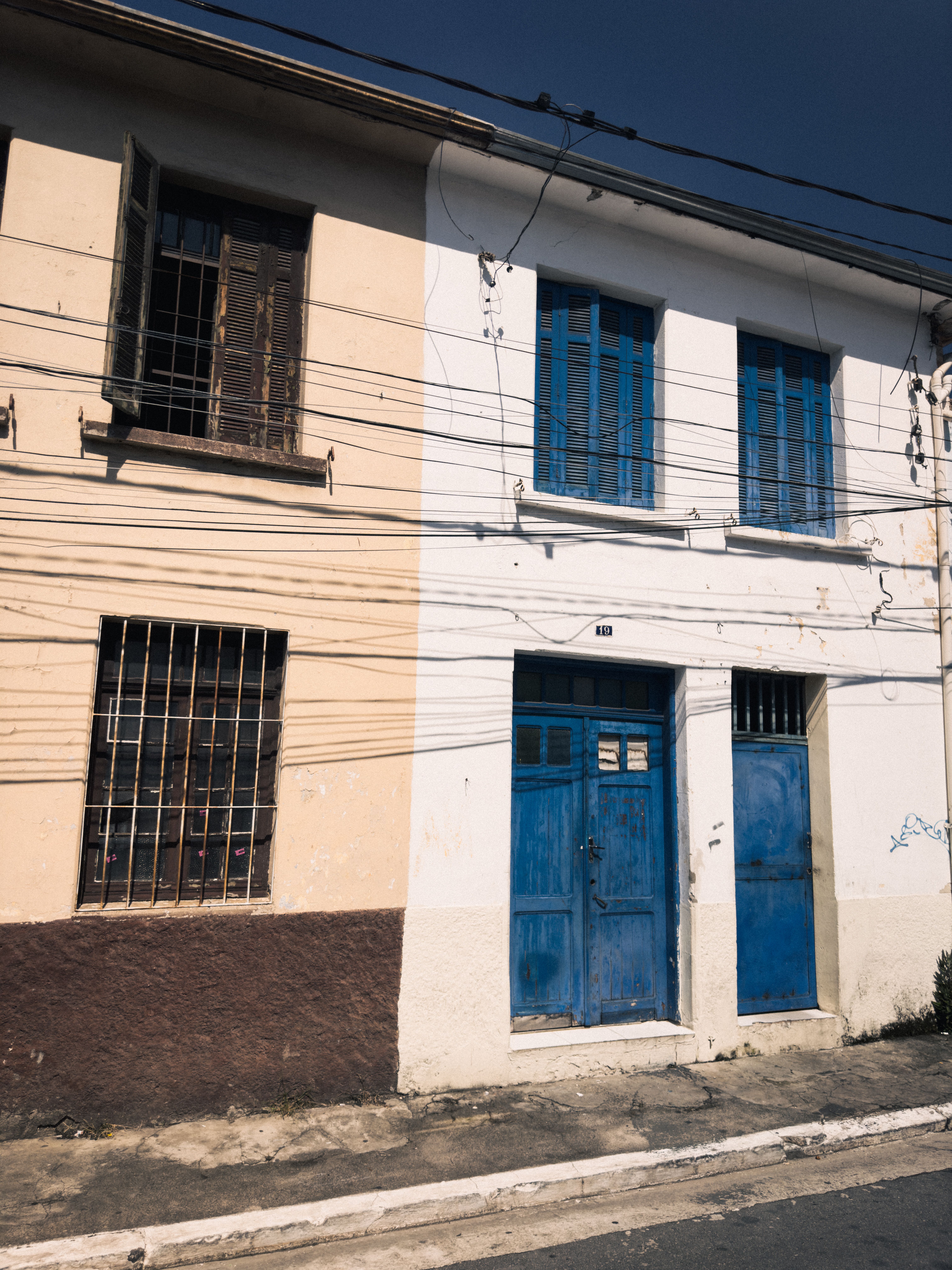 Weathered Building with Blue Doors and Windows · Free Stock Photo