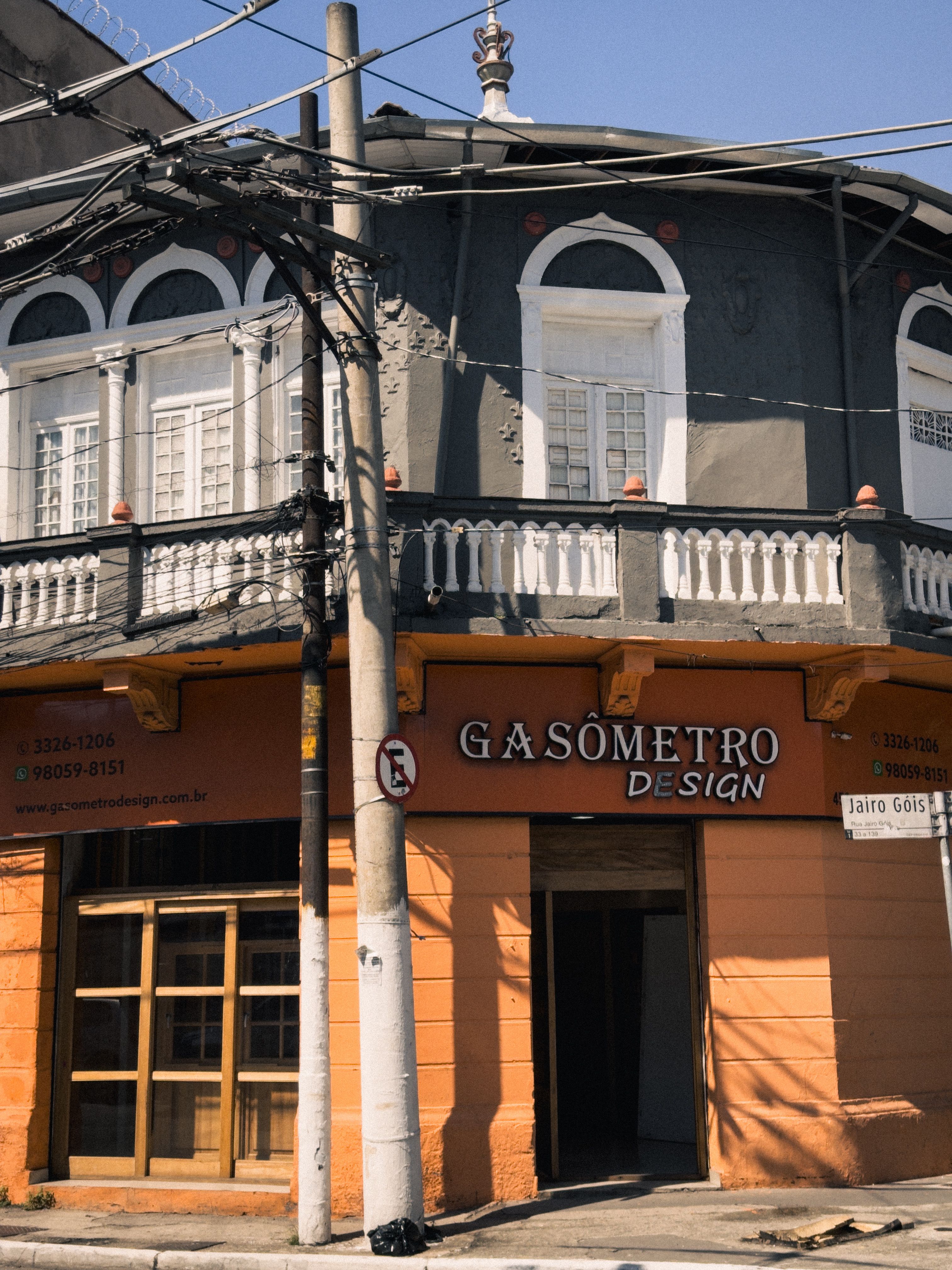 Street view of Gasometro Design building with arched windows and urban details.