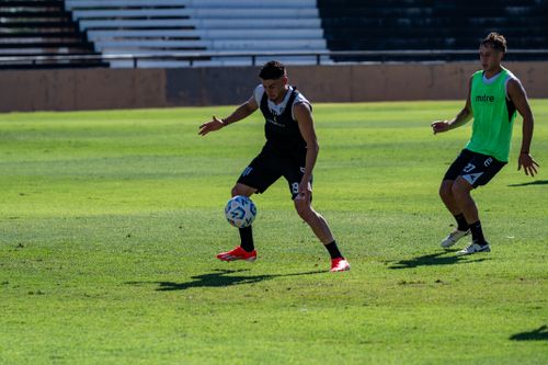 Free Two male soccer players practicing on a sunny day outdoors, focusing on ball control. Stock Photo