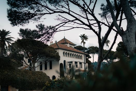 Elegant villa surrounded by Mediterranean greenery in Catalonia, Spain.