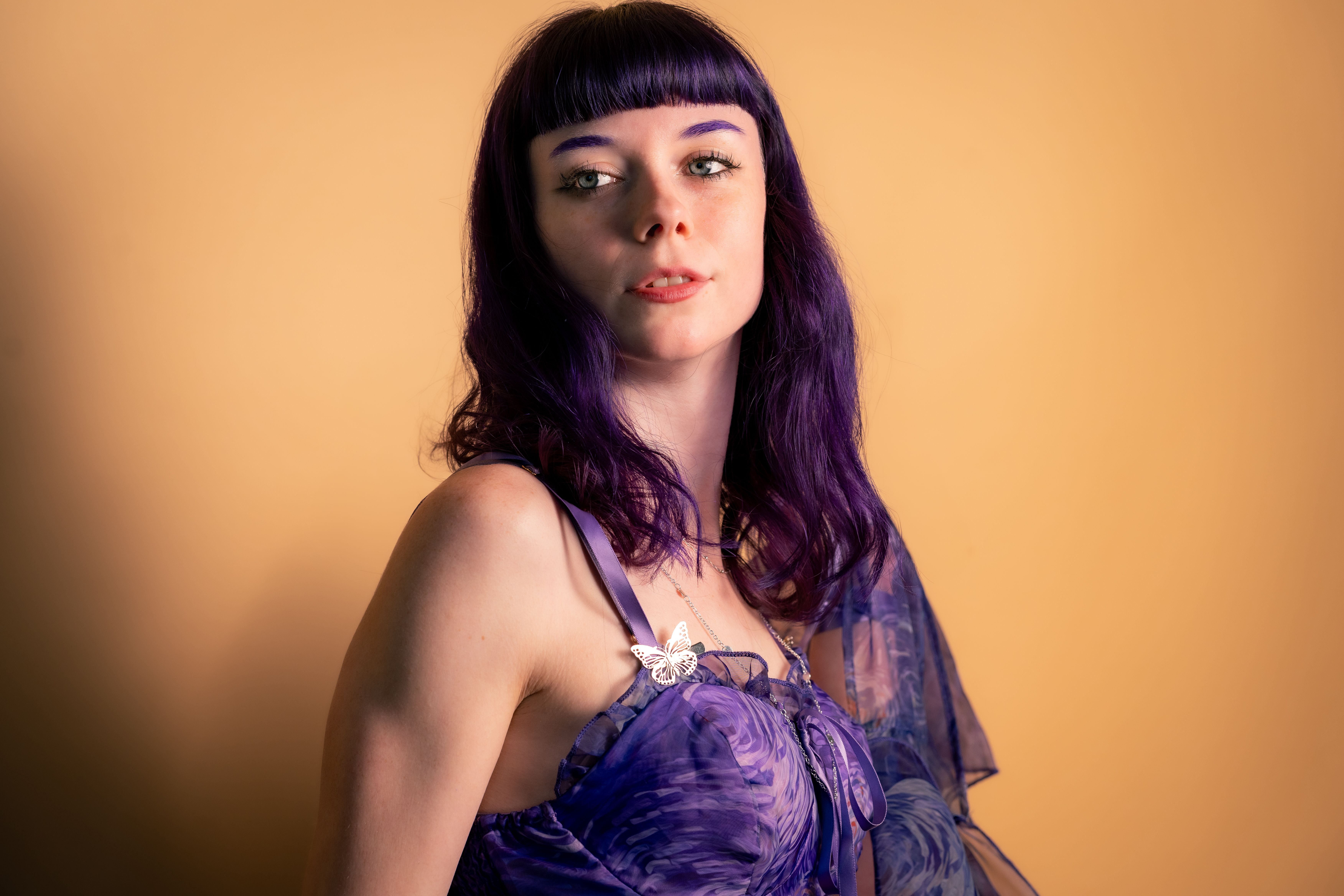 purple hair black dress Attractive Young Woman In Black Dress With Purple Hair Is Sitting On A Leather Sofa. Beauty, Youth Fashion. Hair Coloring. Cosmetics, Make-up. Stock Photo, Picture and Royalty Free Image. Image 97856794