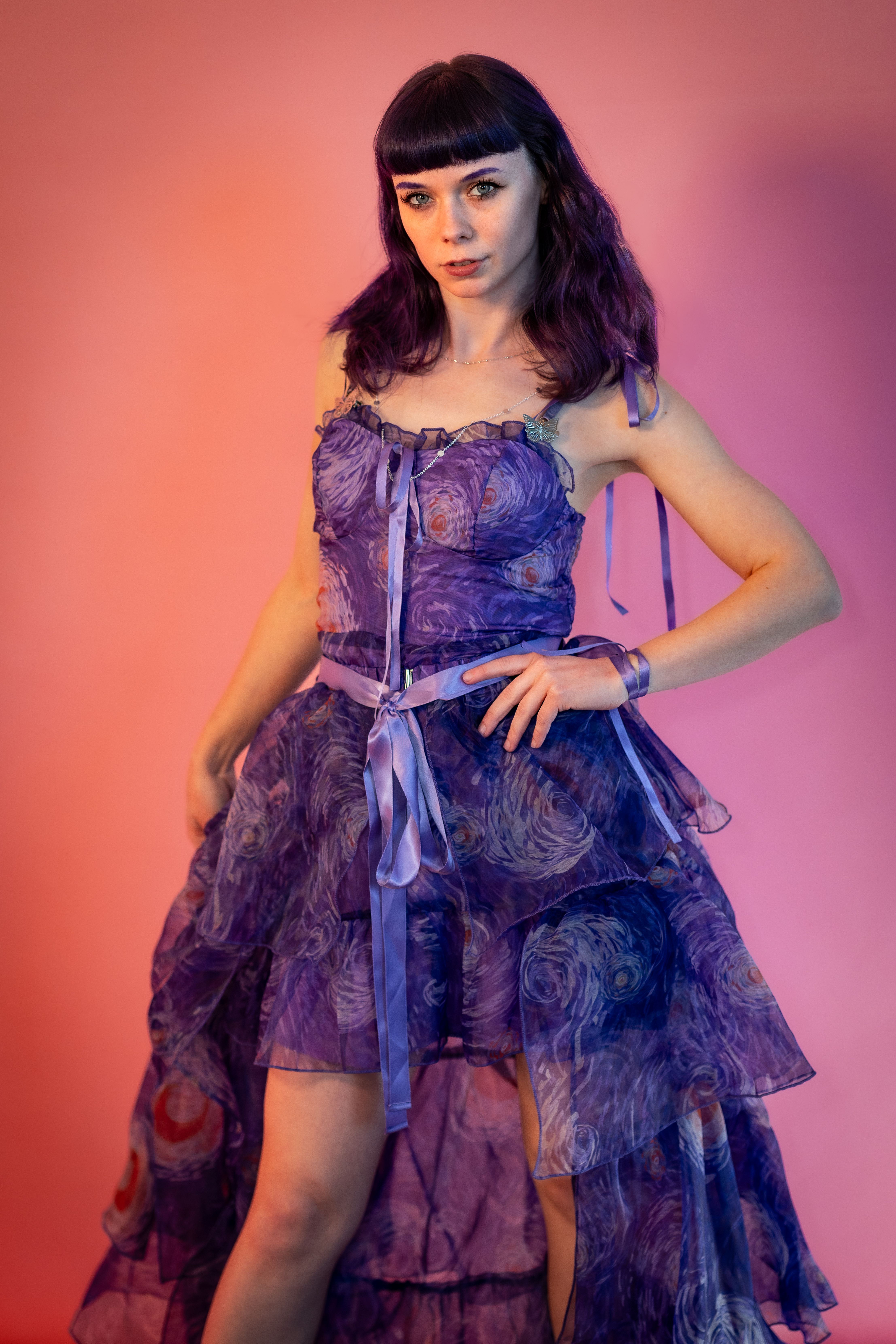 Elegant Woman Posing in a Purple Dress · Free Stock Photo