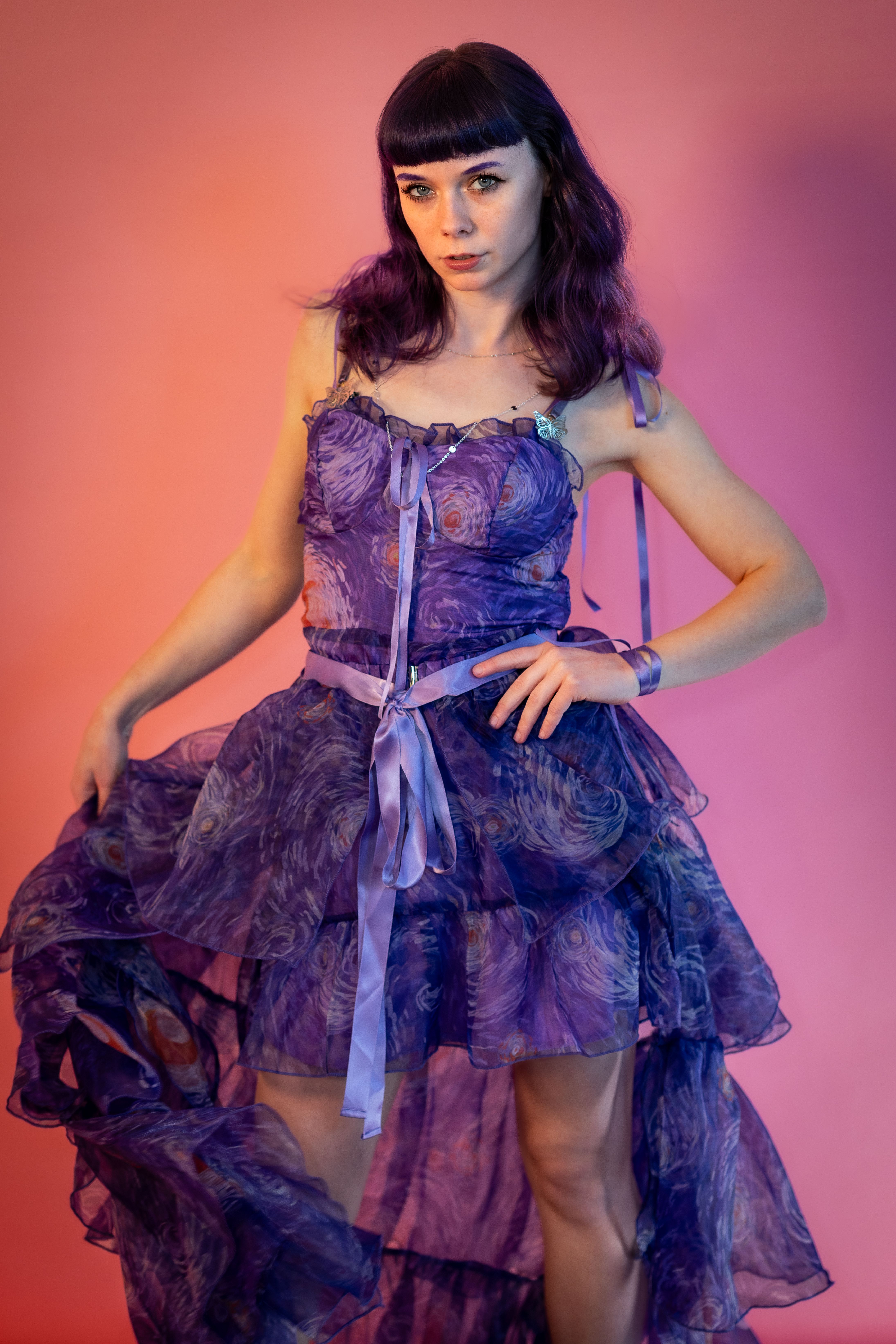 Young Woman in Purple Dress Against Warm Background · Free Stock Photo