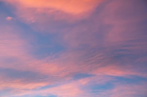 Free Vibrant pink and blue clouds create a stunning sunset scene, perfect for tranquil visuals. Stock Photo