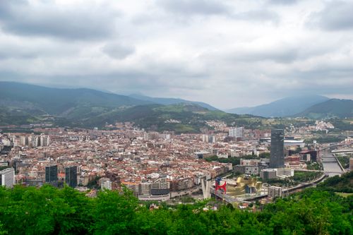 Free Aerial view of Bilbao, Spain featuring the Guggenheim Museum and surrounding urban landscape. Stock Photo