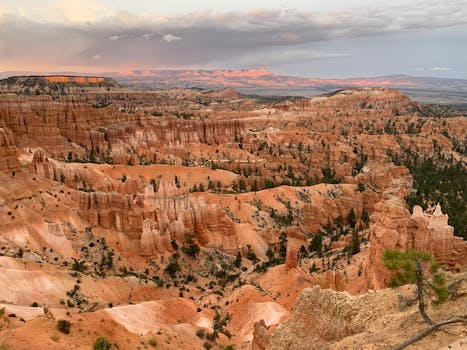 Stunning view of Bryce Canyon's rock formations at sunset, showcasing the park's unique landscape.