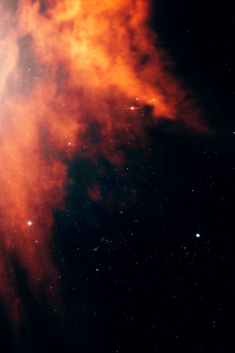 Vibrant nebula captured in deep space, displaying vivid colors against a starry sky.