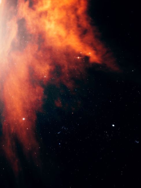 Vibrant nebula captured in deep space, displaying vivid colors against a starry sky.