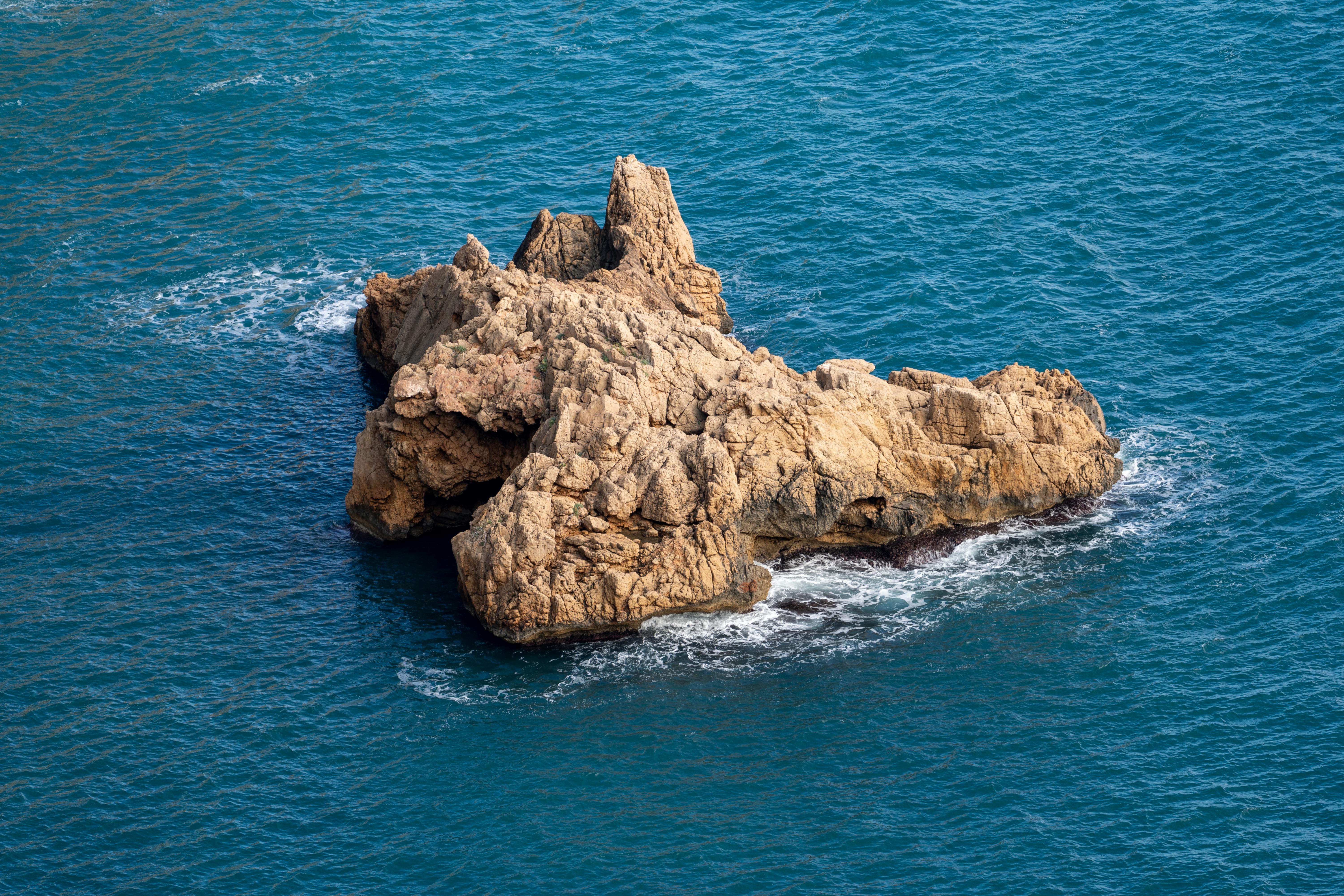 A stunning rocky outcrop in the azure Mediterranean Sea near Jávea, Spain. Perfect for travel and nature enthusiasts.