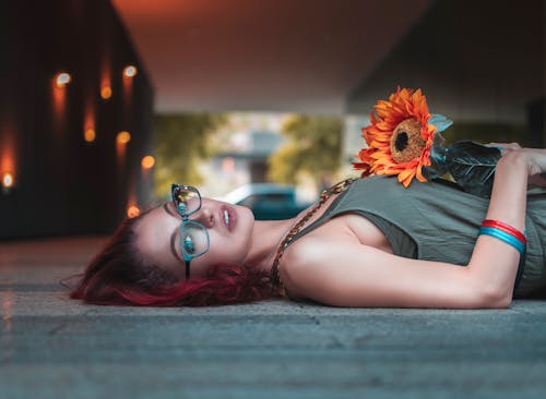 Photo Of Woman Holding Sunflower