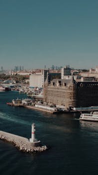 Aerial shot of Haydarpaşa Train Station in Istanbul, showcasing neoclassical architecture by the sea.