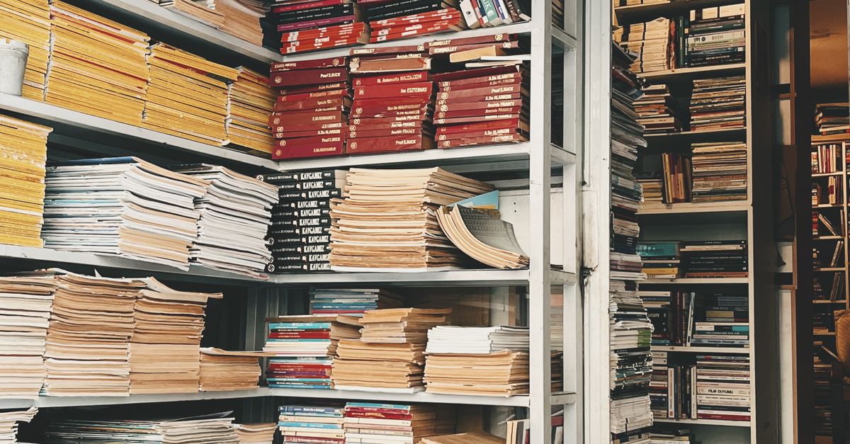 Stacked Books and Magazines in Library Shelves · Free Stock Photo