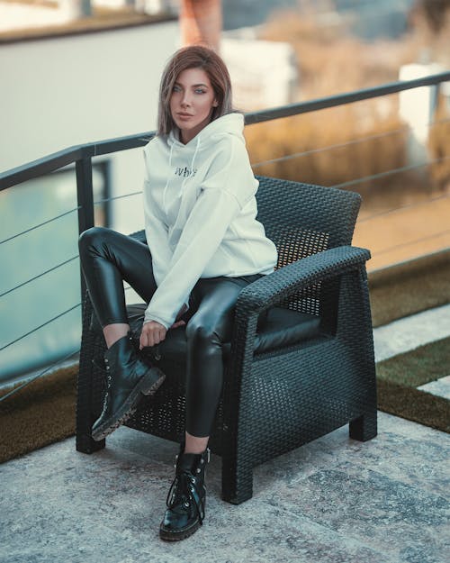 Photo Of Woman Sitting Near Handrails