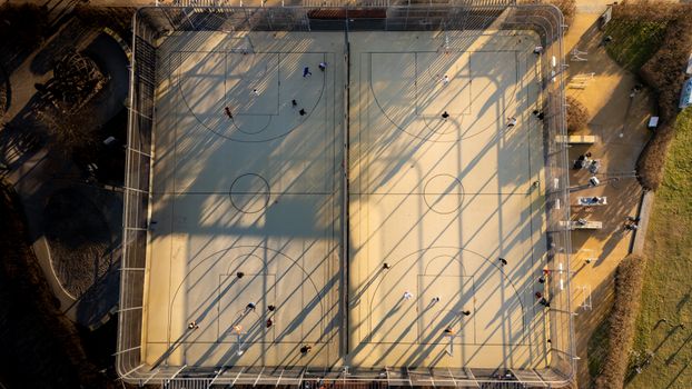 Drone shot of basketball courts in Frankfurt, Germany, showing people playing.