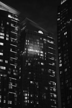 A nighttime black and white view of towering buildings in Doha, Qatar.