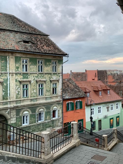 Free Panoramic view of historic colored buildings in Sibiu, Romania under a cloudy sky. Stock Photo