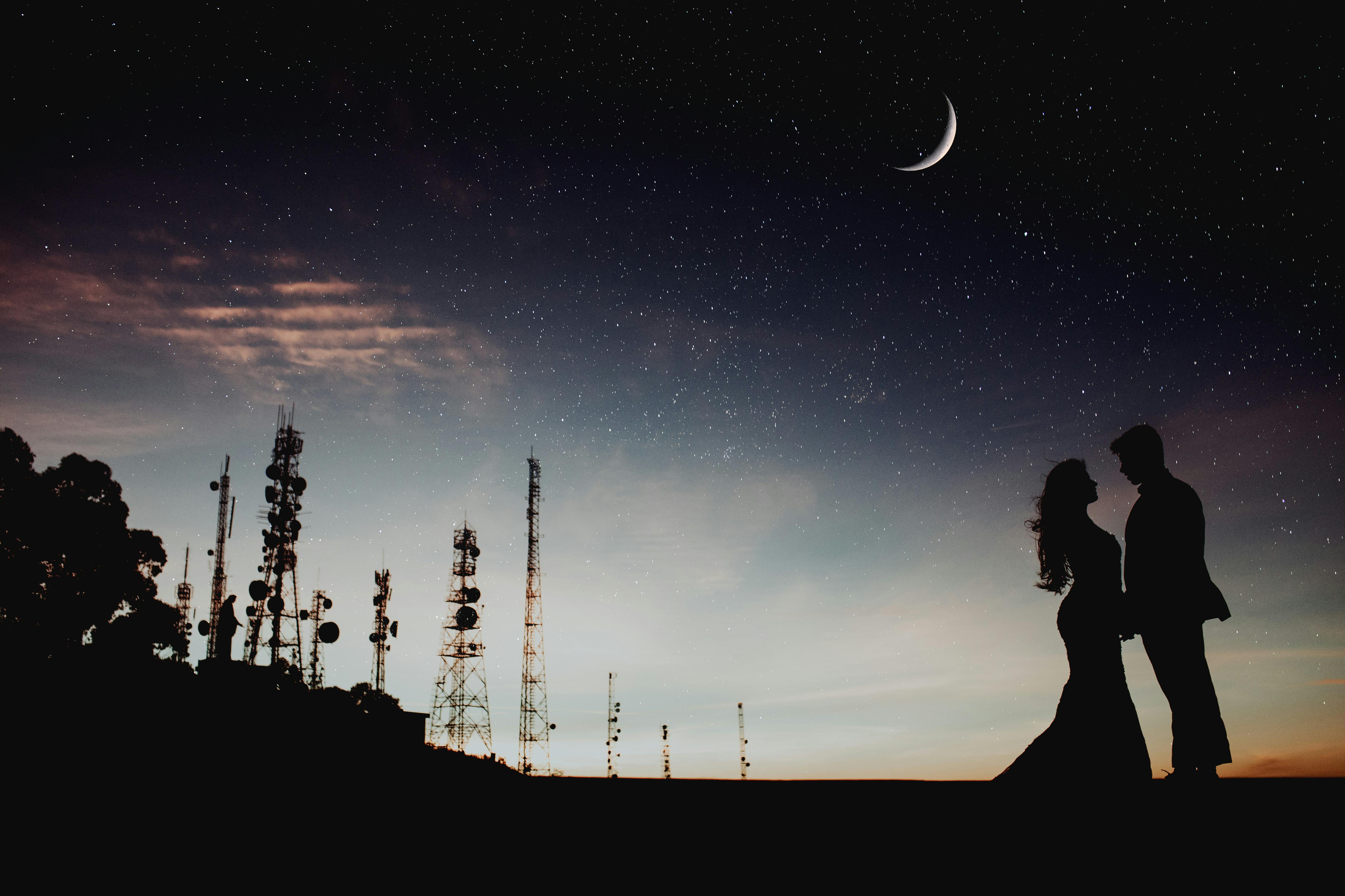 silhouette photography of man and woman standing outdoors