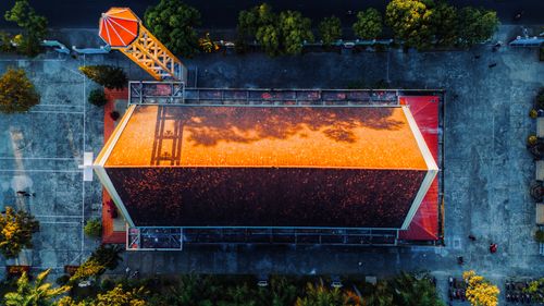 Free Aerial shot of a church with red roof and surrounding greenery in daytime. Stock Photo