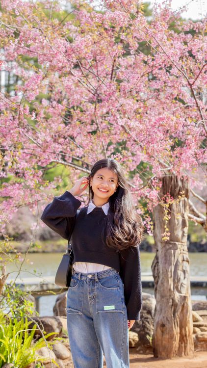 Young Woman Smiling under Cherry Blossoms in Spring · Free Stock Photo