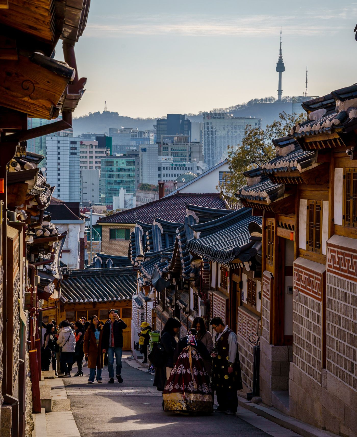 Bukchon Hanok Village with N Seoul Tower behind it Bukchon Hanok Village rooftops in Seoul with N Seoul Tower visible in the distance