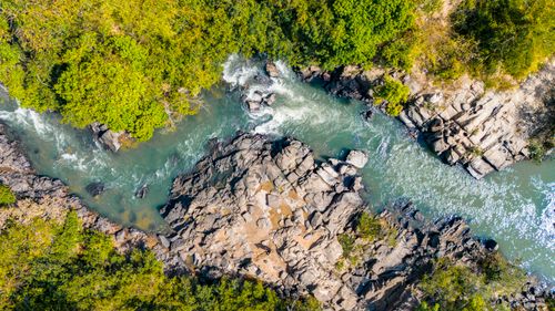 Free Aerial photo capturing the beautiful rocky river and lush greenery in Kon Tum, Vietnam. Stock Photo