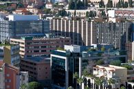 Aerial view showcasing Monaco's modern architectural skyline with skyscrapers and lush greenery.