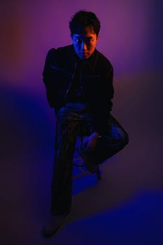 Dramatic portrait of a model in moody lighting, showcasing modern fashion.