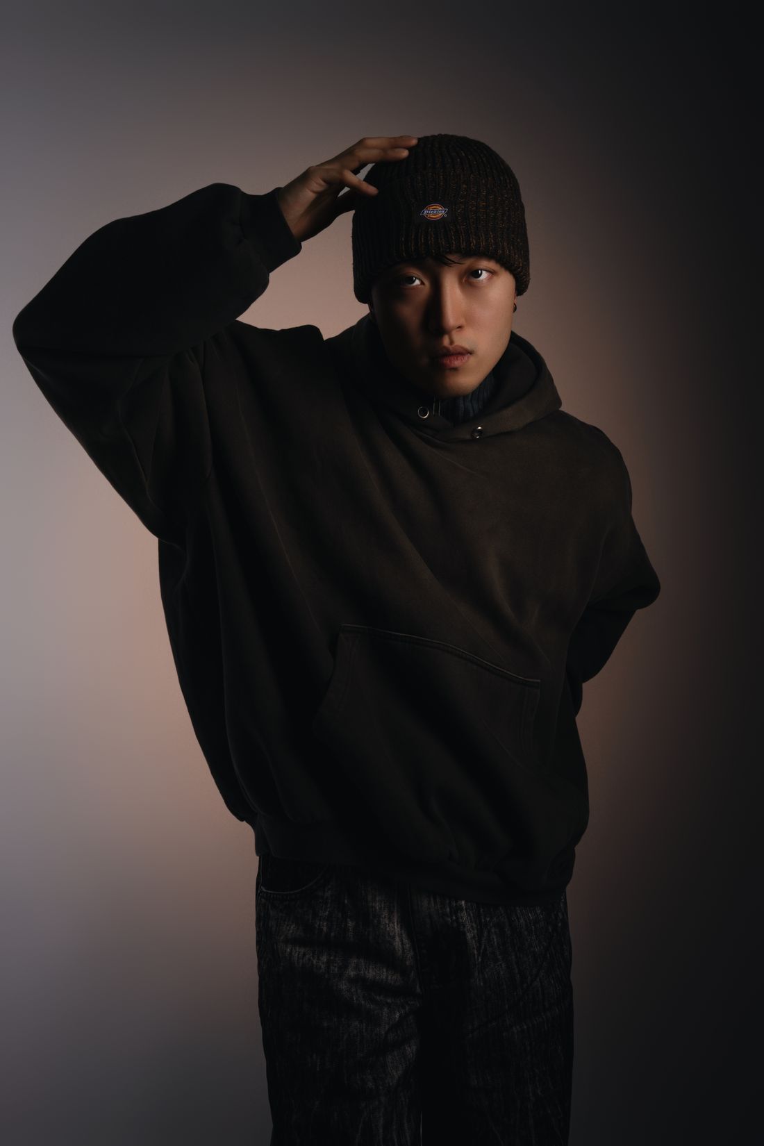 Heavyweight black cotton essentials worn in low studio light
