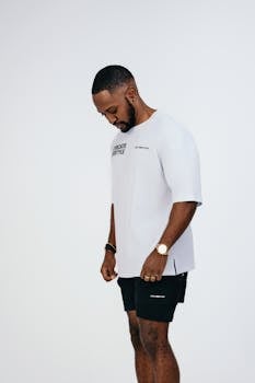 Minimalist portrait of a stylish male model in a London studio, showcasing modern fashion.