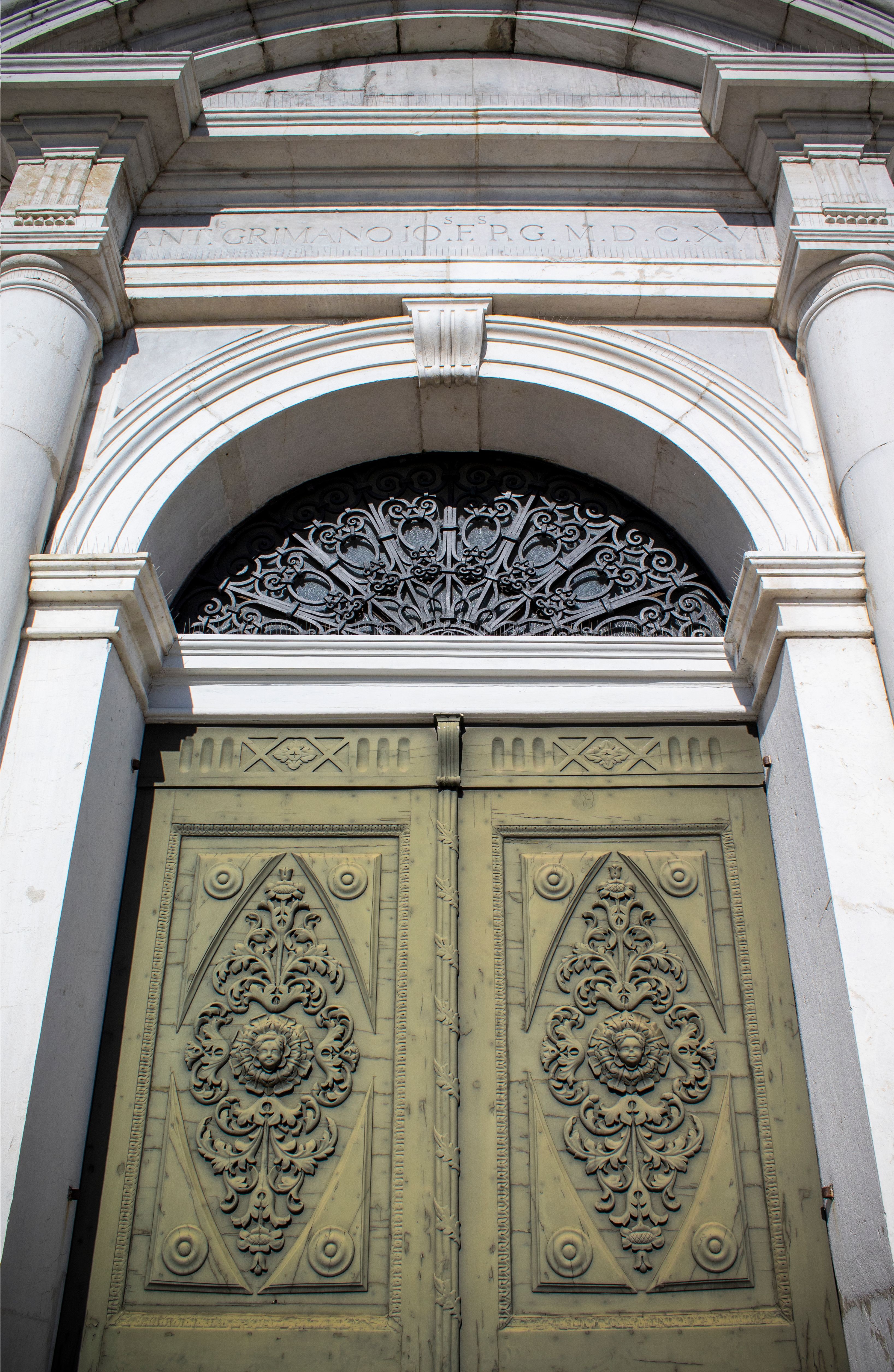 Detailed view of a historic ornate doorway in Palmanova, Italy.