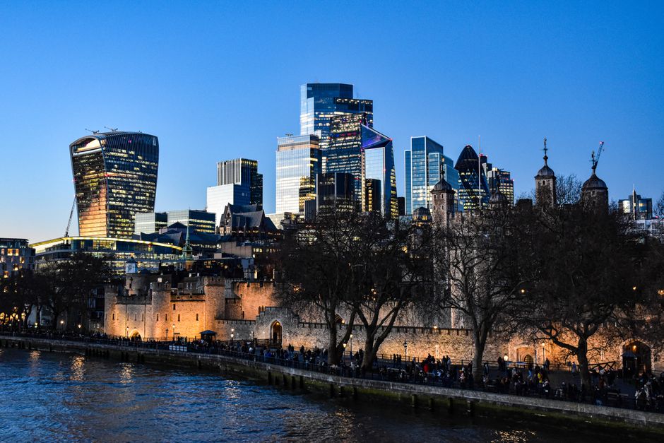 Iconic London skyline view featuring the Tower of London and modern skyscrapers at dusk.