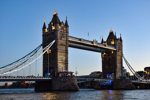 Free Tower Bridge elegantly lit against the evening sky in London, UK. Stock Photo