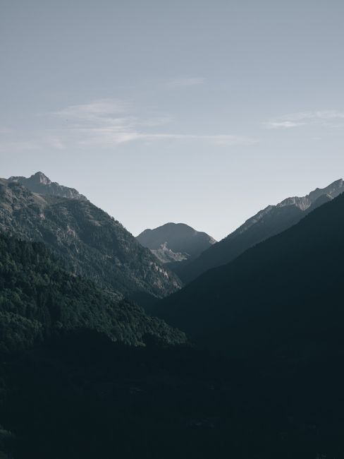 Tranquil mountain range under a blue sky, perfect for nature backgrounds.