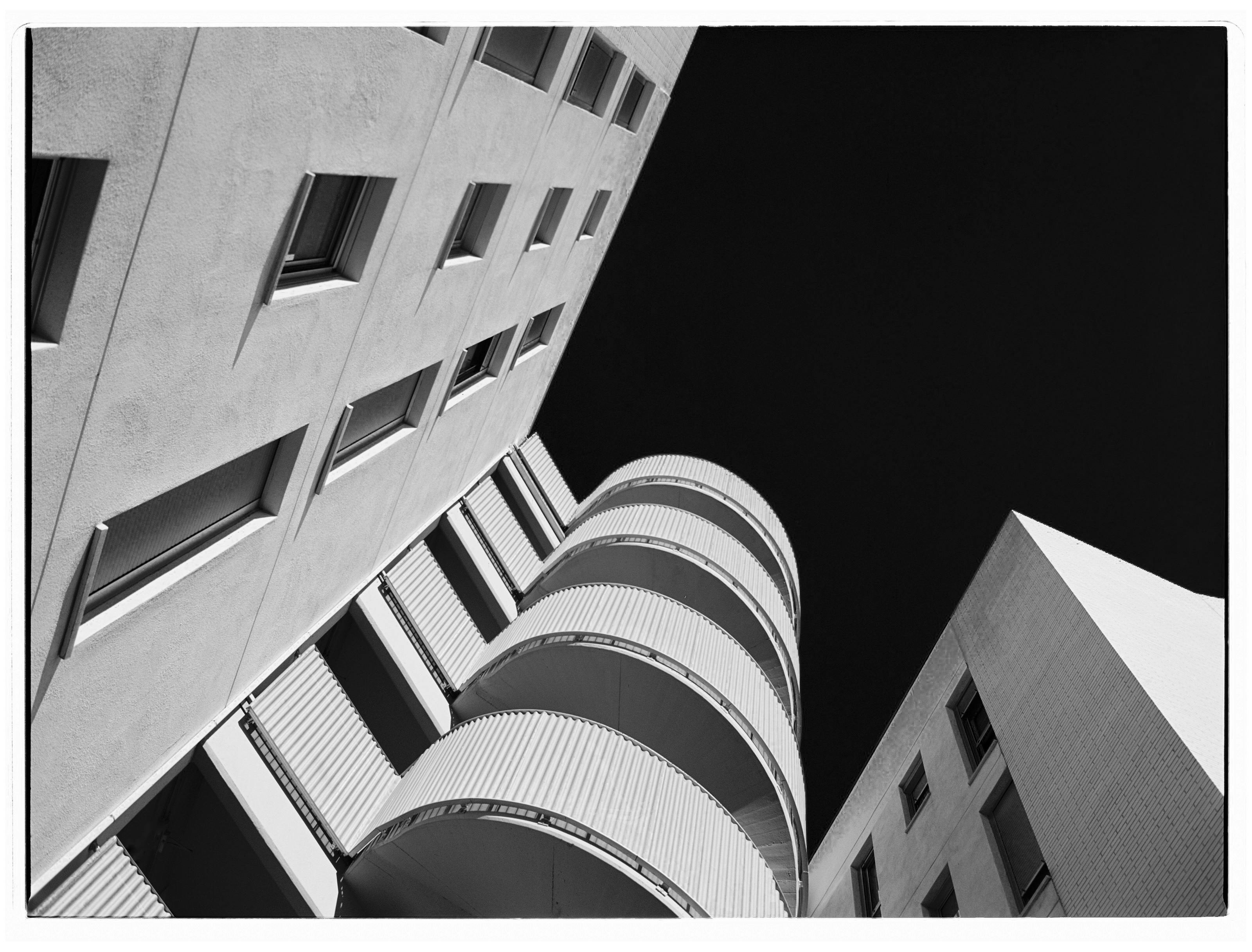 Striking black and white photo capturing modern architecture with geometric angles.