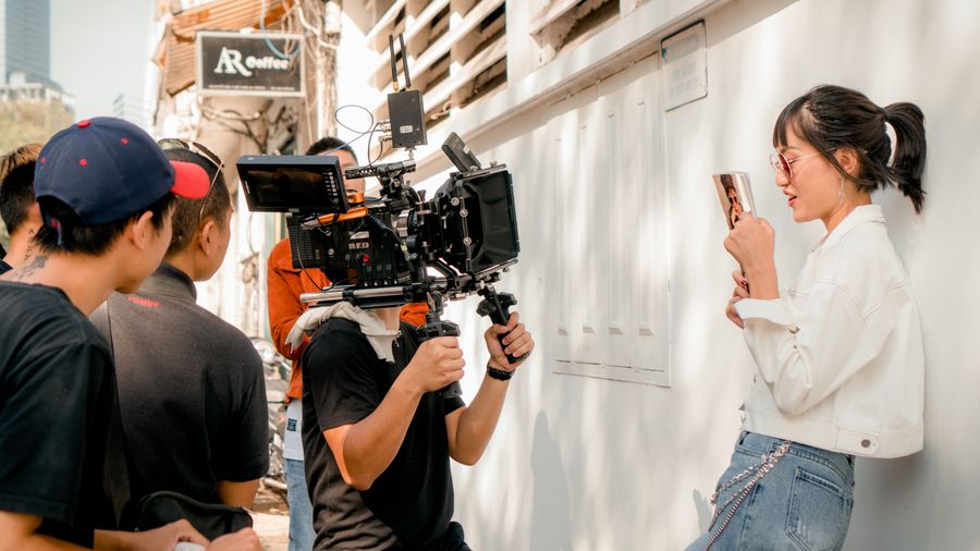 Film crew working on set with a RED camera