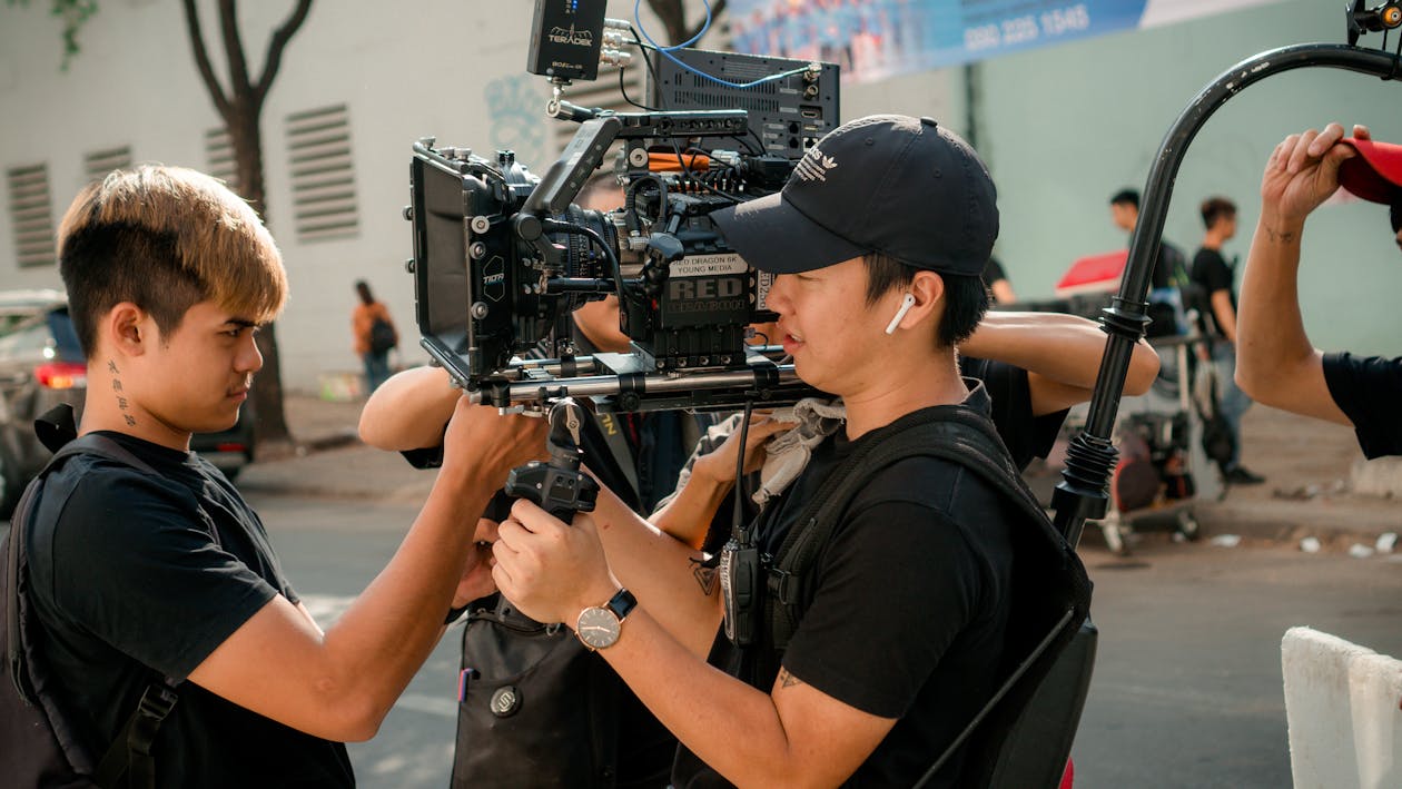 Photo Of Men Holding Camera