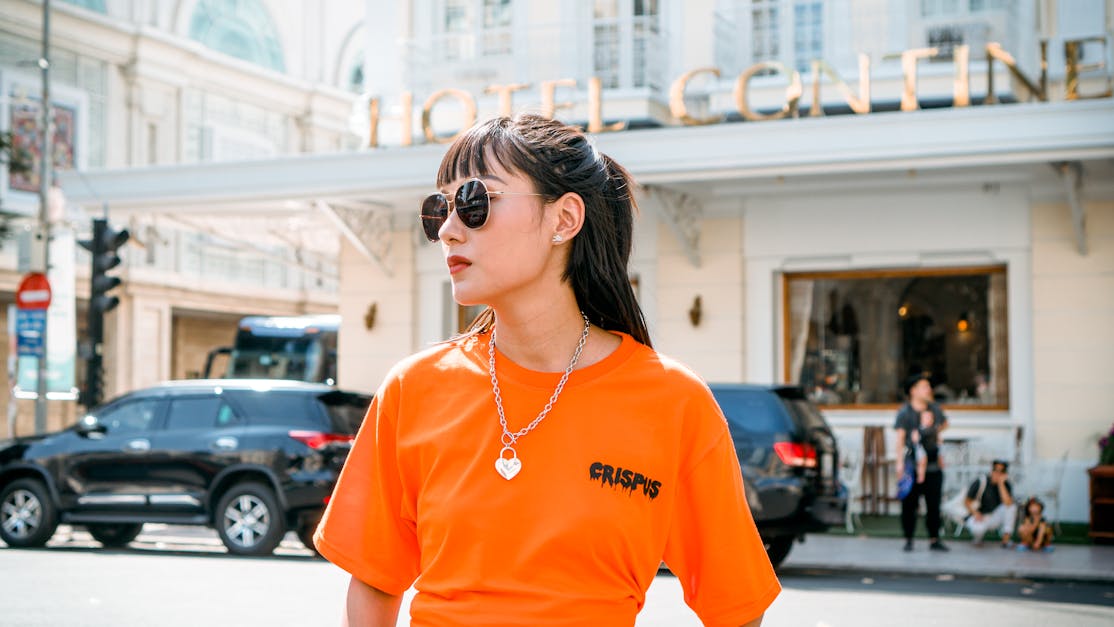 Photo Of Woman Wearing Orange Shirt · Free Stock Photo