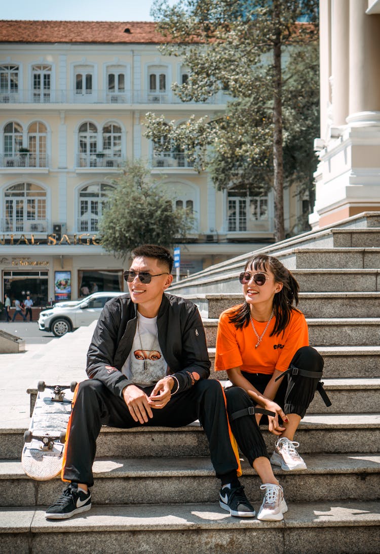 Man And Woman Sitting On Stairs